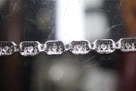 An Art Deco style 18ct white gold and diamond set octagonal link bracelet, 18.5cm.